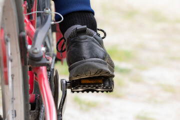 Men's foot on the bicycle pedal.The concept of cycling, active lifestyle.