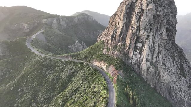 Aerial video of the La Gomera landscape with Roque Agando seen at sunrise golden hour