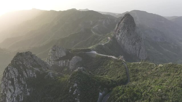 Aerial video of the La Gomera landscape with Roque Agando seen at sunrise golden hour