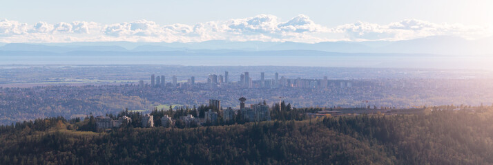 Naklejka premium Burnaby Mountain with Cityscape in Background. Vancouver, BC, Canada. Aerial View from Airplane.