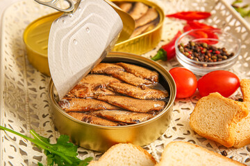 Tray of canned smoked sprats with tomatoes and chilli, closeup