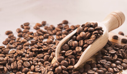 Coffee beans with metal spoon and wooden spoon