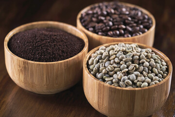 three types of coffee bean in a wooden bowl