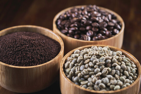 three types of coffee bean in a wooden bowl