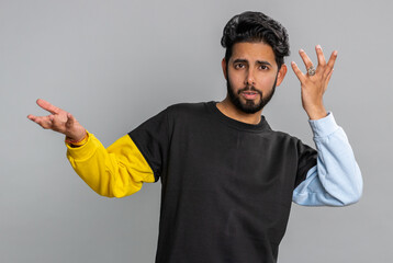 No idea, I dont know answer. Puzzled clueless uncertain indian handsome man raising hands in...