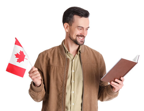 Handsome man with flag of Canada reading book on white background - Powered by Adobe