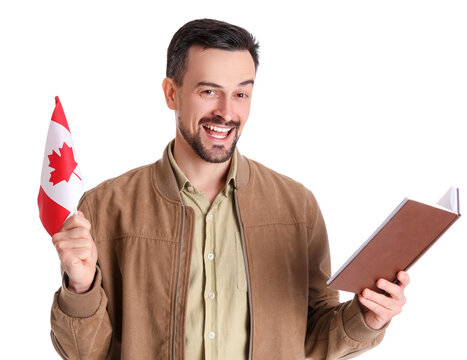 Handsome man with flag of Canada reading book on white background - Powered by Adobe