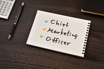 There is notebook with the word Chief Marketing Officer.It is as an eye-catching image.