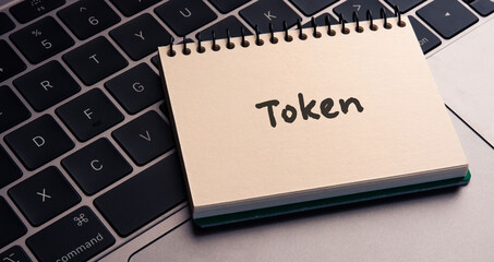 There is notebook with the word Token. It is as an eye-catching image.