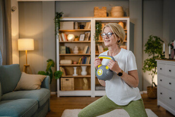 One mature caucasian woman training with kettlebell girya russian bell