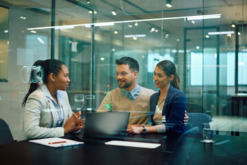 Young couple having meeting with their financial advisor in office.