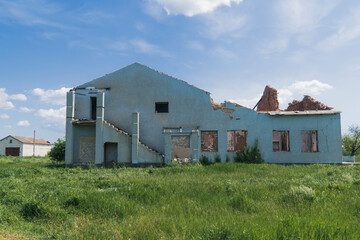 Fototapeta na wymiar Countryside. House destroyed by shelling. War in Ukraine. Russian invasion of Ukraine