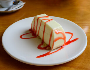 Sweet dessert, cheesecake or flan served with strawberry jam