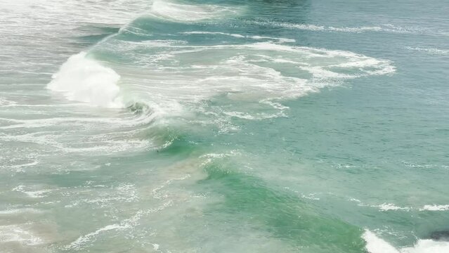 Abstract ocean waves and current swirl and shimmer in aqua and blue