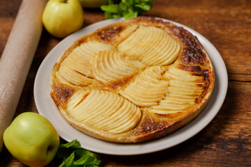 Cooked apple pie on wooden background. Finished semi-finished product.