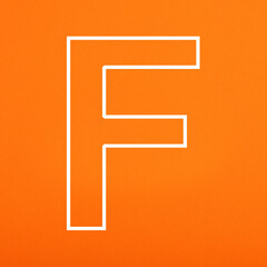 Letter F uppercase written in white color isolated on orange foamy background