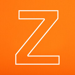 Letter Z uppercase written in white color isolated on orange foamy background