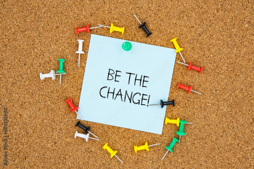 Poster be the change text on light blue post-it paper pinned on bulletin cork board surrounding by multi co