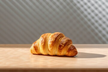 Croissant on a wooden table in front of a striped background. Created with Generative AI tools