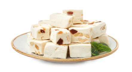 Plate with pieces of delicious nougat and mint isolated on white