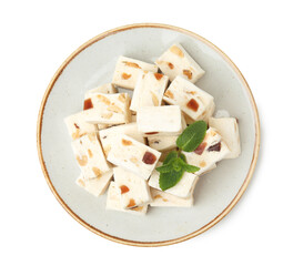 Plate with pieces of delicious nougat and mint isolated on white, top view