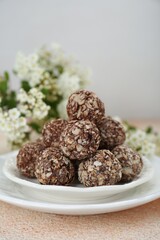 Delicious sweet chocolate candies on beige table