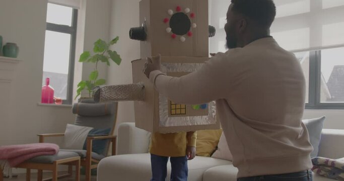 Father and Child playing with Robot at Home