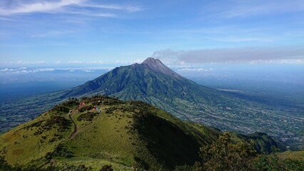 view of active Merapi volcano from the top of mount Merbabu