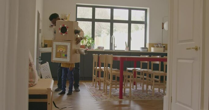Father and Child playing with Robot at Home in Kitchen
