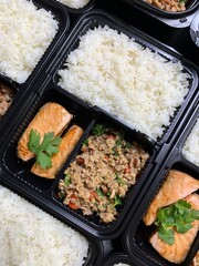 Healthy lunch box with Fried stir basil with minced pork and Salmon with Teriyaki Sauce