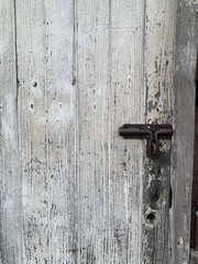 The focus image of vintage white wooden door was bolted