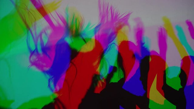 colorful shadows of dancing people disco