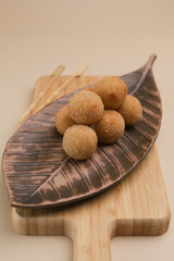 Potato croquettes, piled on ceramic container, isolated on beige background