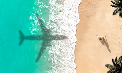 Airplane shadow flying over beautiful exotic tropical beach with woman sunbathing on a sunny cay -...