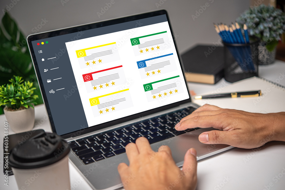 Poster hand using laptop computer satisfaction rating service on desk. customer review satisfaction feedbac