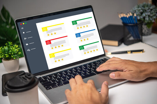 Hand using laptop computer satisfaction rating service on desk. Customer review satisfaction feedback survey client quality concept,Business marketing.