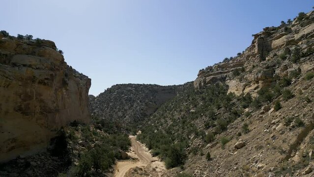 Aerial-Twin bridges of Interstate-70 span the rugged Eagle Canyon located in the geologic anticline formation of the San Rafael Swell in east central Utah-Pulling back