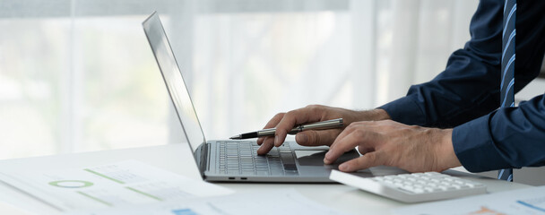 business people working on laptops Analyze business documents with graphs. financial chart Calculate market performance report on digital tablet business data analysis concept.