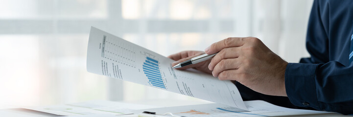 copy space, banner, panorama, businessman working on laptop Analyze business documents with graphs. financial chart Calculate market performance report on data analysis concept.