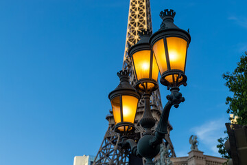 A lamp post with the eiffel tower in the background