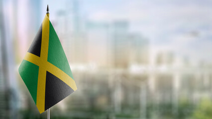 Small flags of the Jamaica on an abstract blurry background