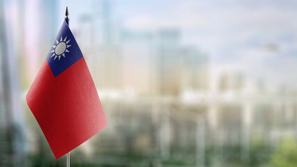 Small flags of the Taiwan on an abstract blurry background