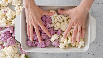Oven-roasted cauliflower florets recipe. Cauliflower, white and purple in baking pan