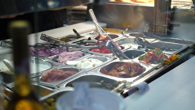 Worker Hands In Gloves Preparing And Filling Up The Container With Langos Toppings. - close up