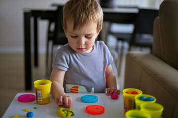 Portrait of little toddler playing at the table