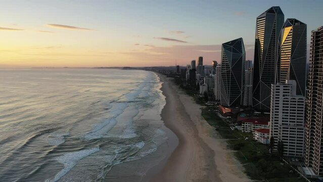 Aerial 180 pan starting with a southernly view towards Broadbeach, ending with a northernly view of Surfers Paradise beach and surrounds at sunrise. Gold Coast, Australia.