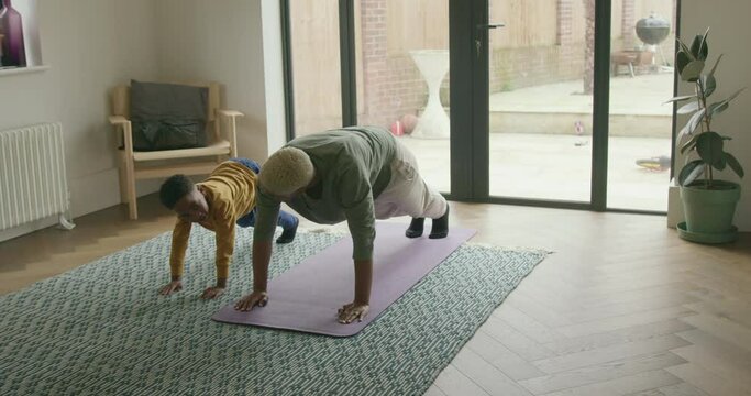 Mother and Son Exercising in Living room at home