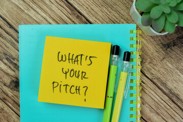 Concept of What's Your Pitch? write on sticky notes isolated on Wooden Table.