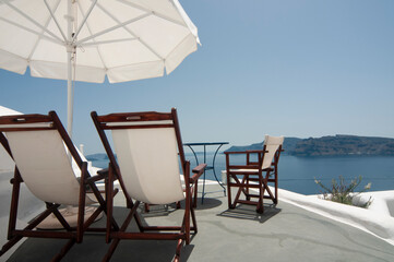 elax in style on the rooftop terrace with breathtaking views of the Santorini Caldera and the Aegean Sea, in comfort under an umbrella on comfortable lounge chairs. Your perfect summer vacation.