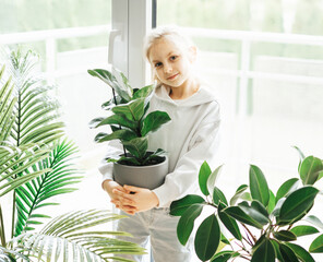 Little girl and houseplants